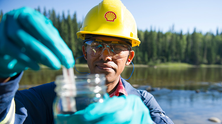 A Shell environmental coordinator takes a water sample at the Greater Deep Basin asset, Canada (photo)