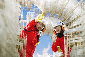 Two engineers inspecting a valve at the Pearl GTL plant in Qatar (photo)