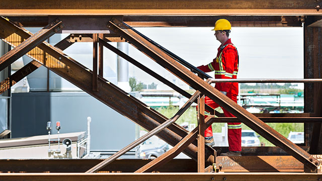 Workers climb stairs within the Quest unit at the Scotford Upgrader, Fort Saskatchewan, Canada (photo)