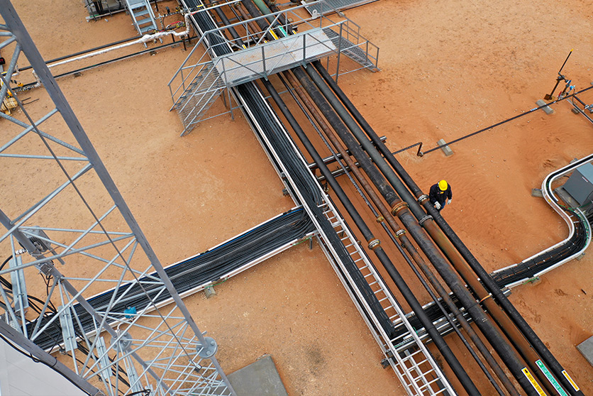 Aerial view of an employee working alongside modular skids and modular pipe racks that are helping to reduce field construction hours (photo)