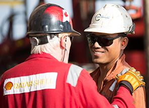 Staff working together on a drilling rig off the coast of Qatar.