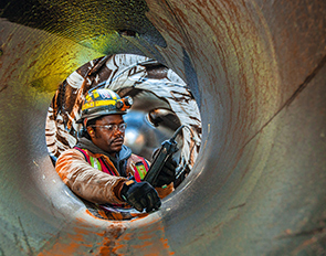 Inspector testing the reliability of equipment at Jackpine mine, Alberta, Canada (photo)