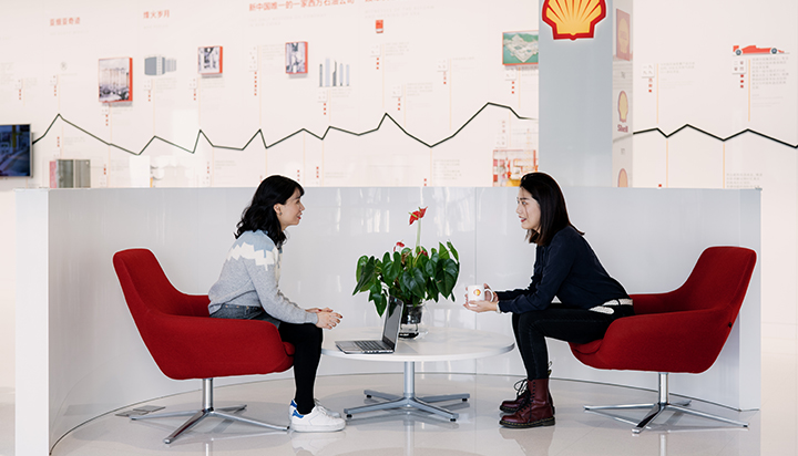 Two women talking at an office in Beijing, China. (photo)