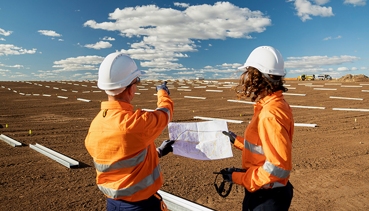 Two people survey the Gangarri solar park construction site. (photo)