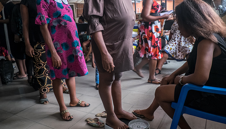 Pregnant women lining up to be weighed at a medical facility in Nigeria. (photo)