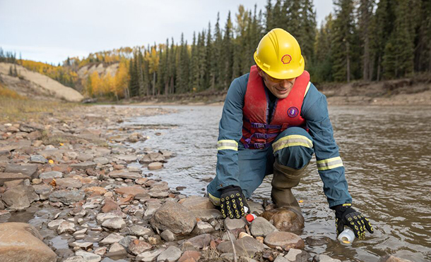 Man taking a water sample to test the quality (photo)