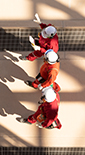 Three men in workwear walking and discussing - view from top (photo)