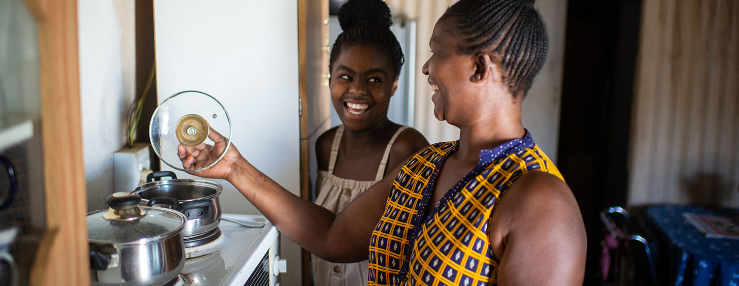 mother and daughter cooking together at home in South Africa (photo)