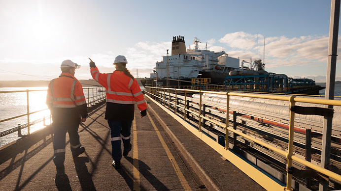 Two Shell employees walking on a pier