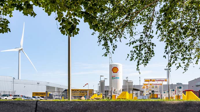 Bio LNG and bio Diesel forecourt viewed through trees.