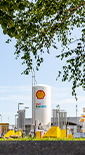 Bio LNG and bio Diesel forecourt viewed through trees. (photo)